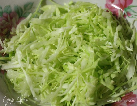 Нарезать капусту и огурец тонкой соломкой. Добавить щепотку соли в капусту и помять ее руками.