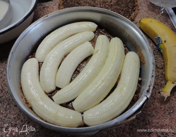 Белки взбить в крепкую пену и частями соединить с ореховой смесью. Разъемную форму в 26 см выстлать бумагой, вылить тесто и выпекать 35-40 минут. У меня тесто очень хорошо поднялось, но после того, как я выключила духовку, оно опало. Но все равно осталось очень нежным. Настолько, что я не рискнула снимать торт с основы разъемной формы.
Бананы очистить и разрезать вдоль пополам. Взбрызнуть лимонным соком. Остывший корж разрезать горизонтально пополам. Нижний корж уложить в разъемную форму, смазать вареной сгущенкой (или шоколадной пастой) и выложить бананы. Бананы лучше брать хорошо поспевшие, но не черные.
