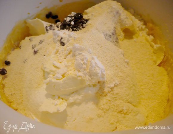 Введем по одному желтки, продолжая взбивать. Добавим цедру апельсина, творог, маскарпоне, пудинг, манку, отжатый изюм и перемешаем на небольших оборотах в комбайне или вручную.