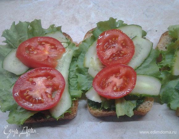 Помидоры нарезать кружками и накрыть ими огурцы.