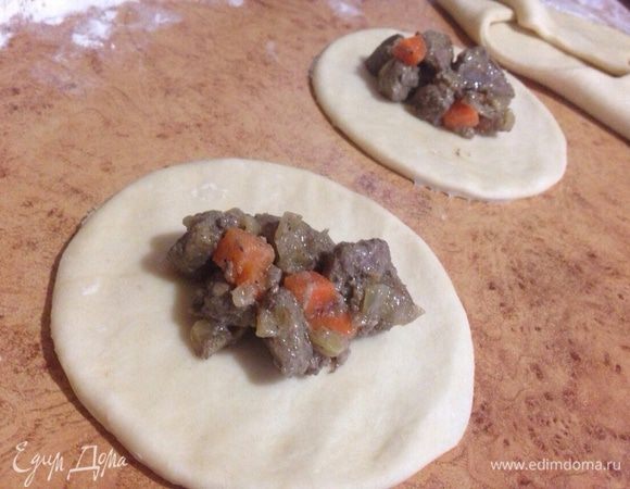 Тесто разделить пополам,вырезать круги,положить ложку начинки.