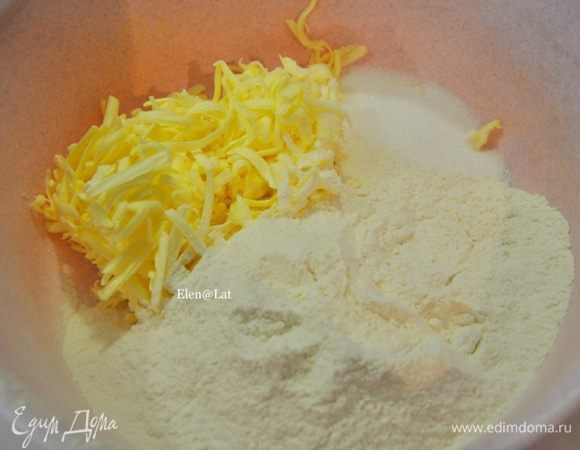 Готовим тесто. Тесто песочное. Трем на терке сливочное масло, смешиваем с сахаром и мукой. 