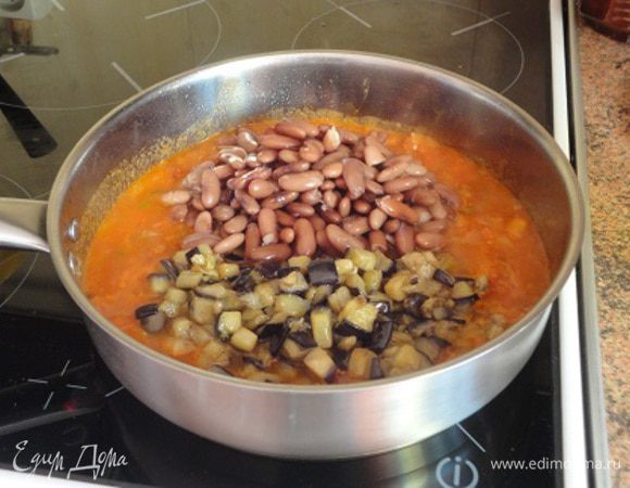 5. Выложить в сковороду фасоль и баклажаны, посолить, поперчить, добавить специи и тушить под крышкой на слабом огне 10-12 минут.