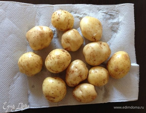 Для салата картошечку лучше выбирать помельче, внешний вид будет презентабельнее. Но мне выбирать не пришлось, так как довольствовалась тем, что передали из деревни.
Разогреваем духовку до 220 градусов.
Картофель тщательно моем и обсушиваем. Посыпаем солью и перцем по вкусу, поливаем оливковым маслом и перемешиваем, чтобы масло равномерно распределилось. Я для этого просто встряхиваю картофель в кастрюле пару раз, накрыв крышкой.