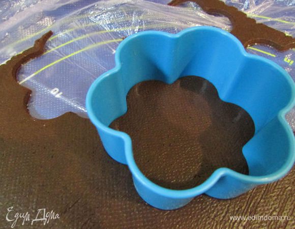 Достать тесто из холодильника и формочкой вырезать печенье.