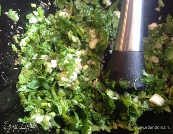 Чеснок, базилик и кинзу мелко нарежьте, положите в ступку и слегка растолките с щепоткой соли.