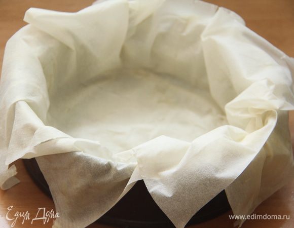 Форму диаметром 20 см смазать маслом. Выложить лист теста. Края должны свешиваться. Так уложить ещё 3 листа теста, предварительно смазанных сливочным маслом.