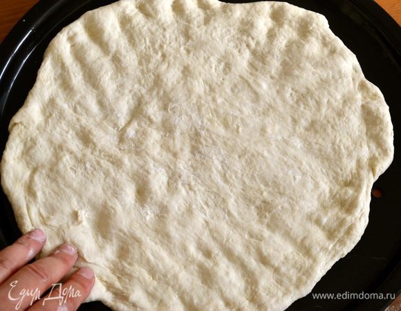 Духовку включить на 220 С.
Готовое тесто обмять, выложить на рабочую поверхность и разделить на две части. Форму для пиццы немного смазать оливковым маслом (или просто противень... Тогда, возможно, Вам не надо делить тесто на две пиццы и можно приготовить одну большую) Сформировать лепешку для пиццы... ))) Накрыть полотенцем и отставить на 10 минут. 