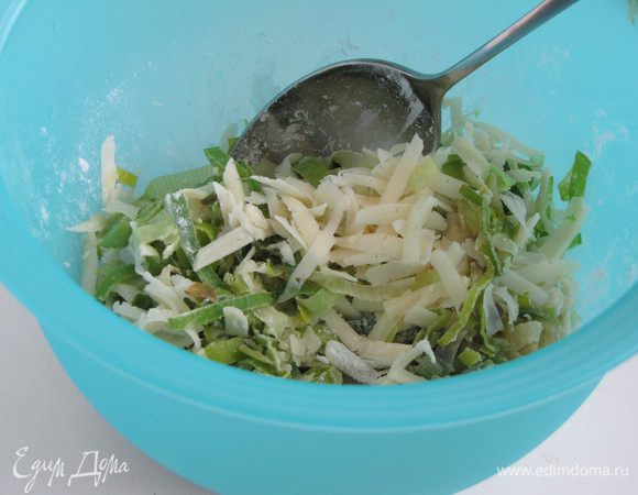 Сыр натереть на крупной терке. Половину натертого сыра перемешать с луком и крахмалом. 