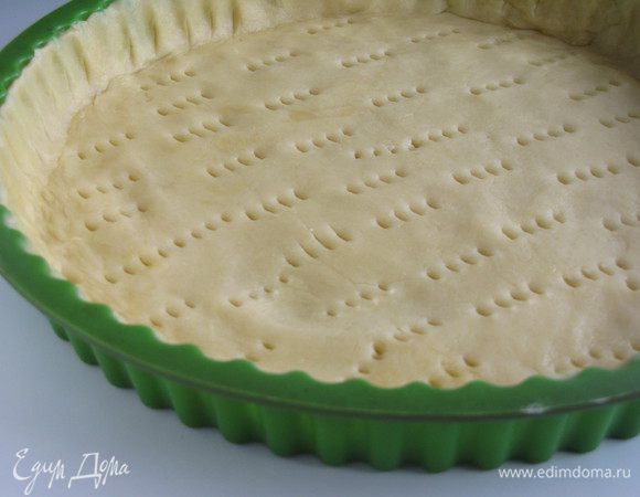 Тесто раскатать в круг и при помощи скалки перенести в форму (d 24 см). Тесто разровнять, свисающие края обрезать. Сделать частые проколы вилкой. Поставить в духовку на 200 град. на 15 минут.