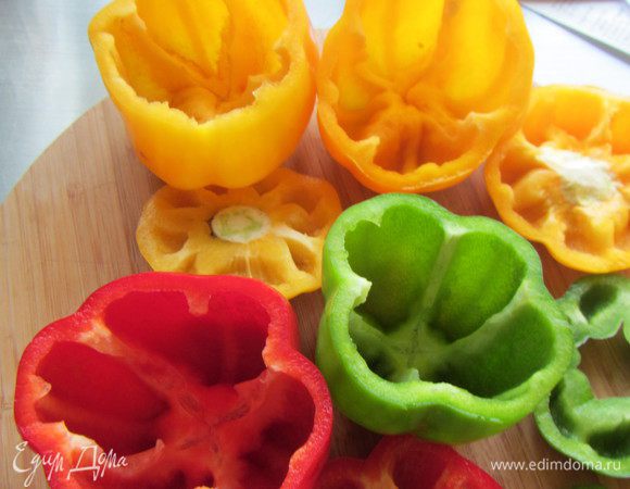У перцев (у меня было 3 больших) аккуратно срезаем шапочки (они нам еще пригодятся). Вырезаем середину с семенами. 
