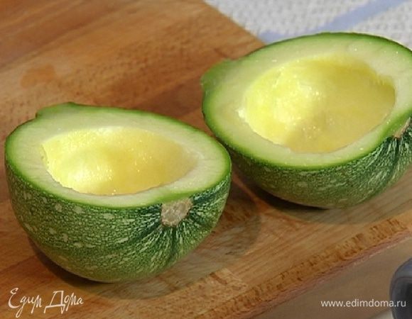 Цукини разрезать вдоль пополам и вынуть ложкой мякоть, не прорезая стенки.