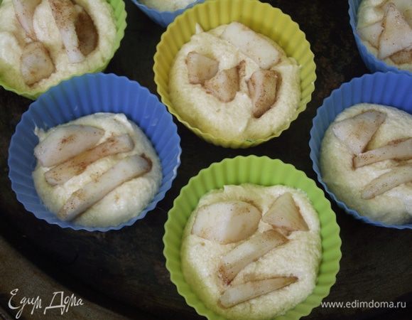 Включаем духовку на 170 градусов. Формочки смазываем маслом и заполняем тестом. Яблоки очищаем о кожуры, нарезаем соломкой, посыпаем немного сахаром и корицей. Отправляем в тесто.