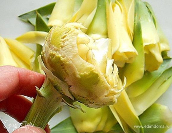 Очистите артишоки.
P.S. Если не имели с ними дела, то делается это следующим образом: удалите внешние грубые листья. Часть листьев, которые остались отрезаем поперек.