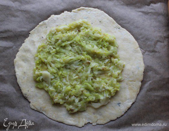 Выложить по центру порей, оставив свободные края лепешки около 3-4 см