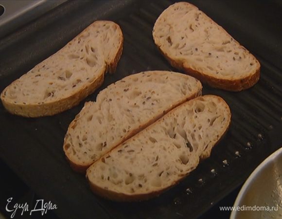 Разогреть в сковороде-гриль 1 ч. ложку оливкового масла и обжарить хлеб с одной стороны.