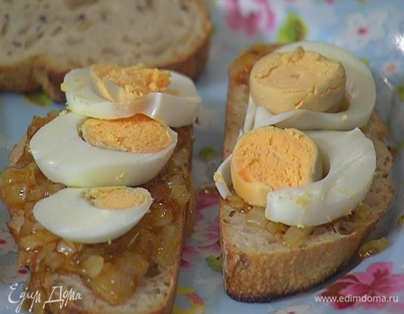 На гренки с соусом выложить нарезанные яйца, посыпать порванными руками листьями кинзы и накрыть гренками, намазанными маслом.