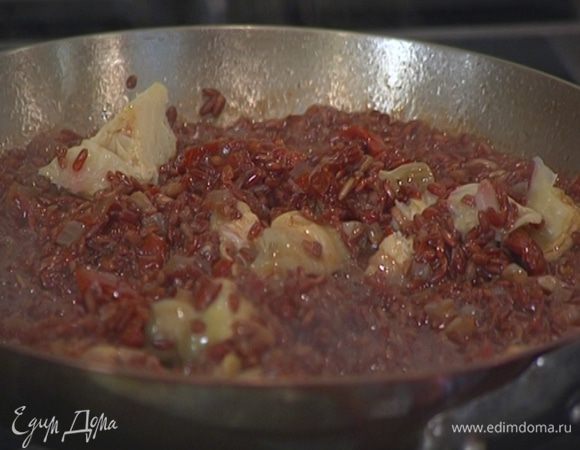 Когда рис будет почти готов, влить соус, оставшийся от цыпленка по-восточному, добавить вяленые помидоры и артишоки, все перемешать и выключить огонь.