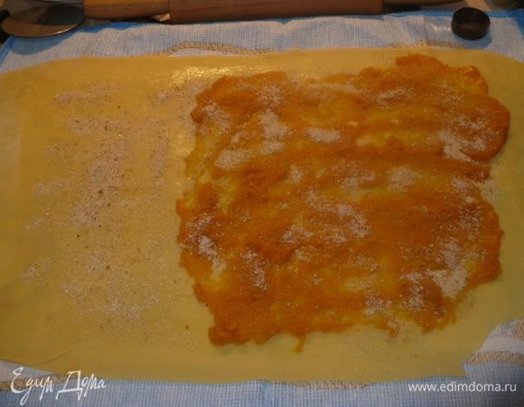 Тесто смазать растопленным сливочным маслом, затем выложить тыкву, посыпать смесью из сахара, сухарей и корицы.