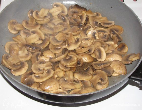 Шампиньоны нарезать тонкими пластинками и поджарить на масле до зарумянивания.