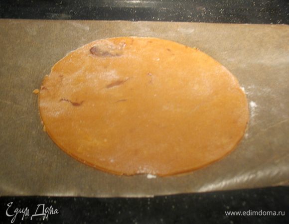 Раскатываем тесто на пергаменте диаметром 16 см. Перекладываем тесто с пергаментом на противень и выпекаем в разогретой до 160°С духовке 5-6 минут. 
