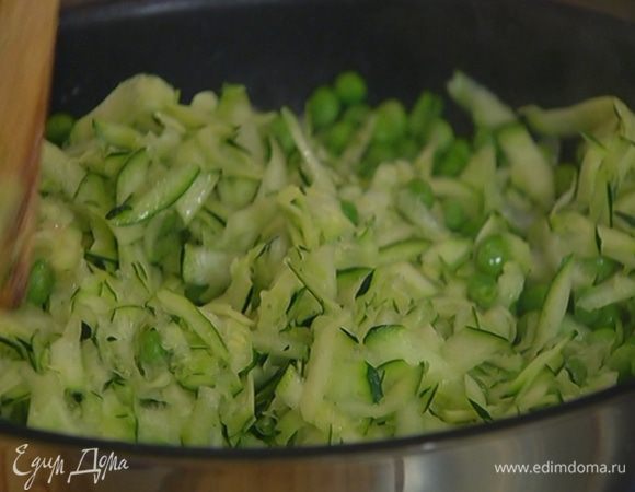 Зеленый горошек и натертый цукини выложить в сковороду с луком и чесноком, посолить, поперчить, перемешать и прогревать на медленном огне несколько минут.