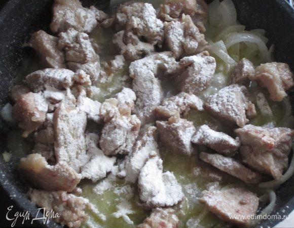 Вернуть мясо в сковороду к луку,посыпать через ситечко мукой и обжарить 2 минуты.