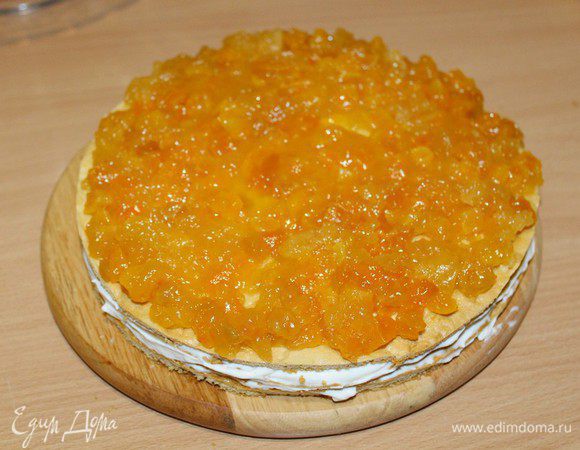 Положить второй корж, выложить на него всю начинку из кураги. Положить третий корж, смазать медовым сиропом, выложить крем.