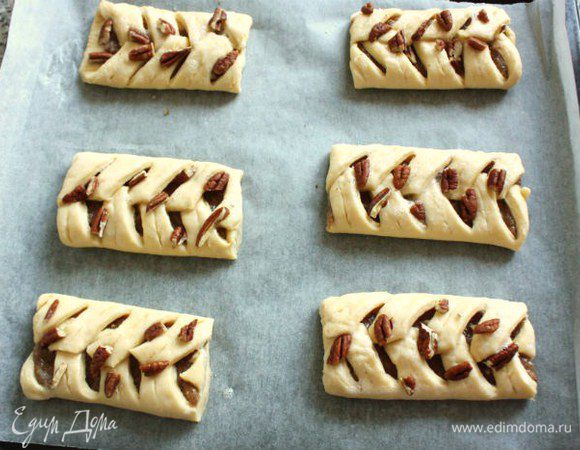 Каждую «косу» нарезать на булочки по 12 см.
Переложить их на застеленный пергаментом противень и убрать в холодильник на 20 минут, затем смазать взбитым белком, посыпать рубленными орехами и выпекать в разогретой до 200*С/с конвектором до 180*С/ газ 6 духовке до золотистого цвета (20-25 минут).