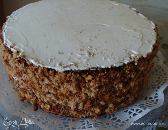 Далее уже стемнело, поэтому фото неяркие. Смазать верх торта оставшейся сметаной и посыпать бока торта бисквитной крошкой. Переложить торт на тарелку.