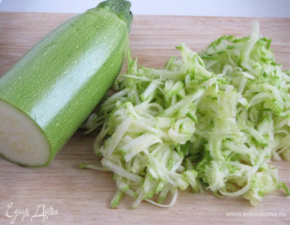 Натереть на крупной терке цукини или кабачок.