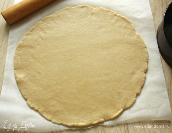 Раскатать тесто на присыпанной мукой поверхности или между 2 листами пекарской бумаги в круг 34 см диаметром.