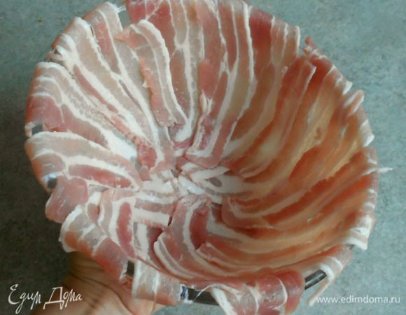 Выстилать жаропрочную форму беконом, размещая его от центра к периферии и немного изгибая (как бы по спирали). Это даст красивую поверхность готового блюда и более плотное прилегание к мясу. 