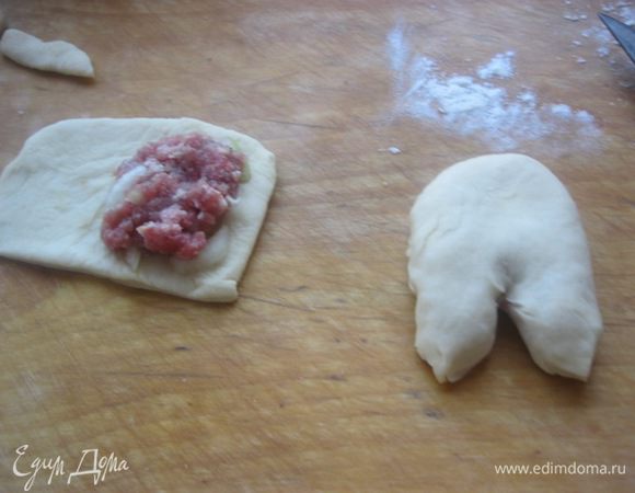 Из второй части раскатать два небольших прямоугольника, выложить начинку, края плотно защипать.
С одной стороны сделать надрез, имитируя копытца.