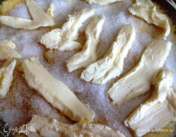 По истечении этого времени переложить тесто в смазанную растительным маслом форму 21 см и распределить равномерно по форме. Накрыть полотенцем и поставить в теплое место на 30 мин. Затем сверху насыпать сахар и по нему равномерно распределить масло (или перемешать масло с сахаром и равномерно распределить по поверхности теста).