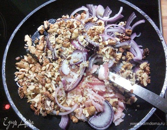 Разогреть 2 ст. ложки масла и поджарить лук, бекон и орехи в течении 2 мин. 