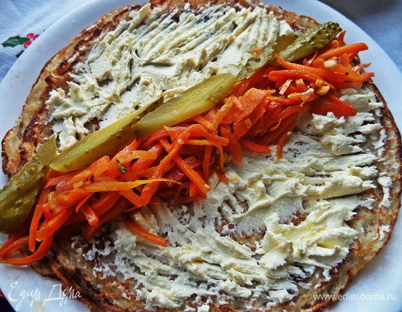 Укладываем лентой пару ложек морковки по-корейски и маринованный огурчик нарезанный.