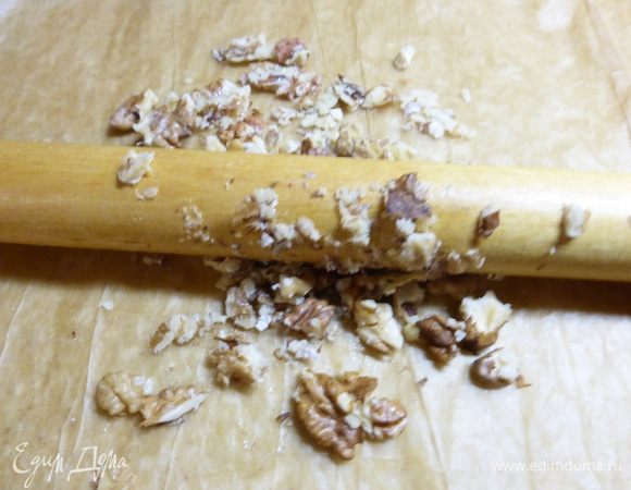 Для пропитки готовых коржей готовим крем (хотя крем - это громко сказано). Измельчим грецкие орехи.