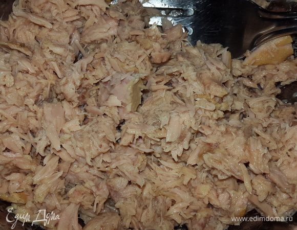 С тунца сливаем масло в сковородку и разминаем вилкой.