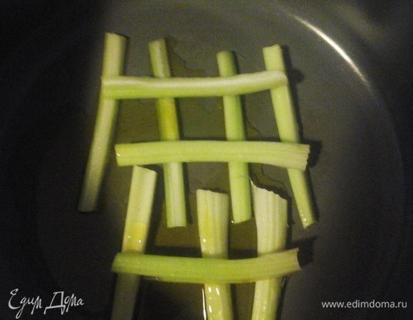 Разрезать сельдерей по длине и выложить на дно кастрюли (это придаст вкус и послужит защите от пригорания трески).