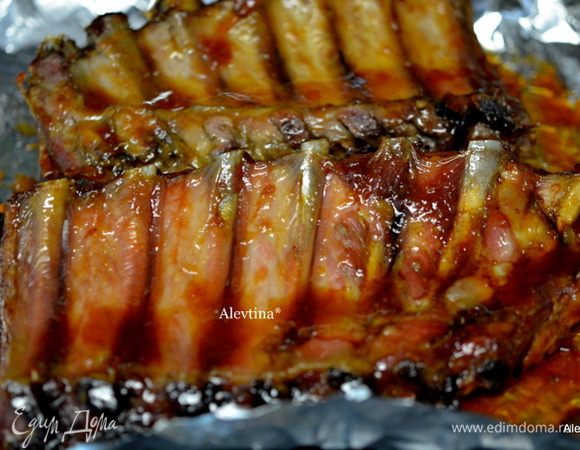 Готовые ребрышки смажем медовой глазурью со всех сторон, вернем в духовку на несколько минут. Лаковые ребрышки разрежем на порции.