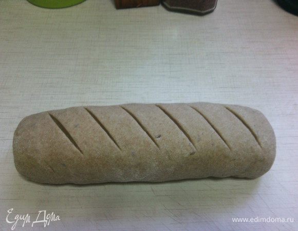 Сформировать из теста булку (я свой свернула рулетом), выложить на противень, застеленный пергаментом. По верху сделать надрезы. 
И оставить хлеб на расстойку на 40 минут, прикрыв полотенцем.