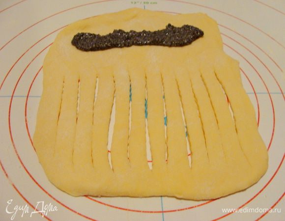 Тесто: молоко залить теплой кипяченой водой, размешать, распустить в получившейся смеси дрожжи, дать дрожжам подняться. За это время растопить масло и остудить до теплого состояния. Взбить вилкой желтки, добавить в молочно-дрожжевую смесь, туда же отправить масло.
Перемешать и замесить тесто, добавив муку. Поставить тесто в теплое место, чтобы оно поднялось.

Начинка: мак смешать со сгущенным молоком. 

Отщипнуть от теста кусочек, который помещается в ладошке, раскатать, сделать продолговатые надрезы на 2/3 получившегося объема. На свободный край положить начинку.