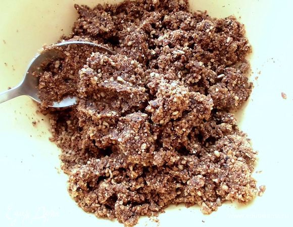 Перемолоть грецкие орехи и семечки. Добавить кэроб, мёд и немного воды. Тщательно перемешать. Должна получиться однородная и пластичная масса. 