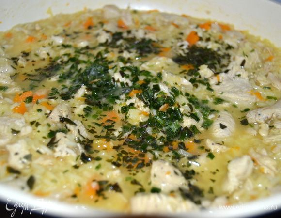 Добавить зелень. У меня лук резанец и базилик. Как кончится жидкость и рис будет мягкий, так и готово.