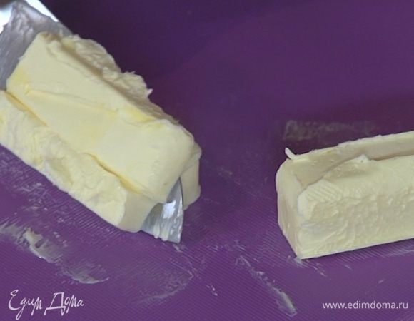 Предварительно охлажденное сливочное масло нарезать небольшими кубиками.