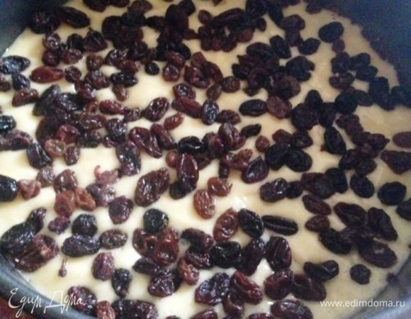 Выливаем вторую треть теста и посыпаем сверху заранее запаренным в кипятке и просушенным изюмом. Выпекаем также.
