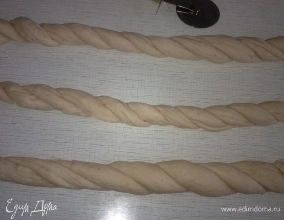 Тесто отлично поднялось. Я не раскатываю его скалкой, а руками осторожно растягиваю в разные стороны. Оно мягкое и с ним легко работать! Прорезаем тесто на 6 длинных полос. Скатать 6 жгутов. Соединяем по 2 жгута вместе. Скручиваем их в одну сторону. В итоге у нас получились 3 скрученных части.