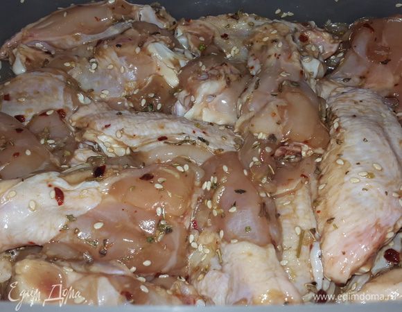 Крылышки (без кончиков) моем, обрезаем лишнюю кожу, разрезаем на 2 части и  складываем в контейнер. Солим, перчим, посыпаем травами, добавляем бальзамико, соевый соус, 2 ст.л. оливкового масла, выдавливаем чеснок, добавляем кунжут и руками перемешиваем. Накрываем пленкой и отставляем в сторону мариноваться.