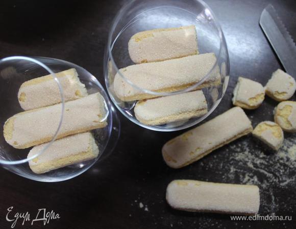 Берем емкость, в которой планируем подавать десерт (у меня бокалы для коньяка) и выкладываем слой печенья, подгоняя его по размеру. Оно очень хорошо и ровно режется зубчатым ножом для хлеба. 
У меня на слой уходило по 2 палочки.